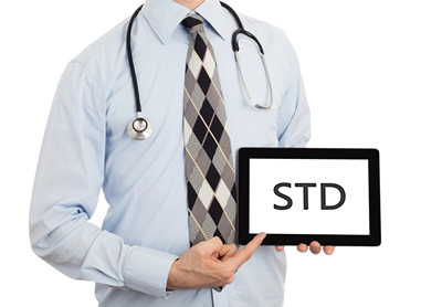 Physician hold a sign that reads STD